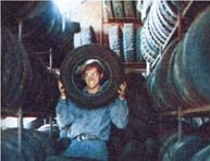 Why is this man smiling? He just saved over $100 by buying his "new" tires in a used auto parts yard.